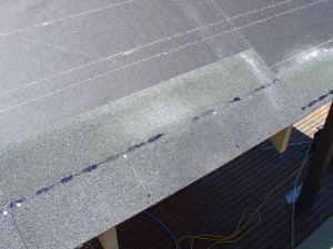 First course of asphalt roof shingles aligned with the starter course