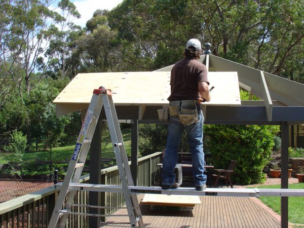 ]Nailing the first sheet of plywood securely into place