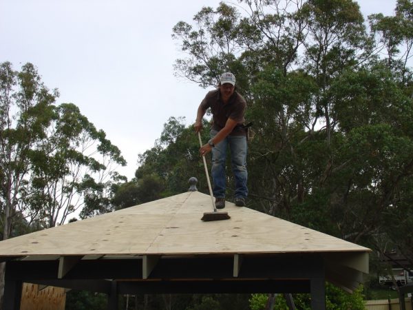 Sweeping the sawdust off the gazebo deck