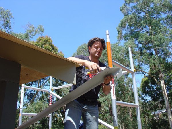 Cutting the metal drip edge with tin snips