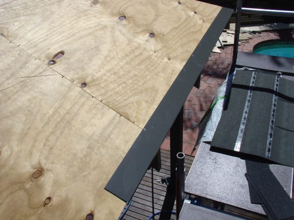 Nailing the drip edge onto the lower edge of the ply